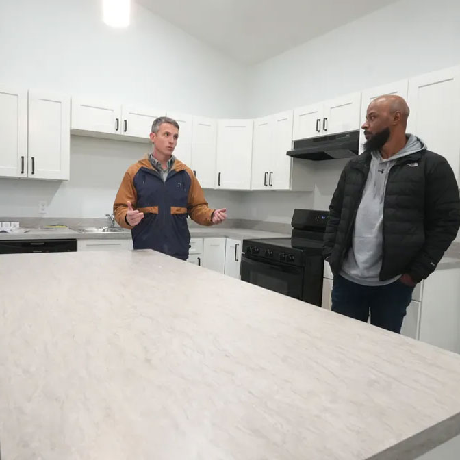 Don Ackerman, executive director of Canton For All People, left, and Gino Haynes, deputy director, provide a tour of one of the three-bedroom Family Apartments being built in Canton. Kevin Whitlock/Massillon Independent